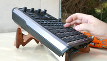 A hand next to an SP-404 MK2.